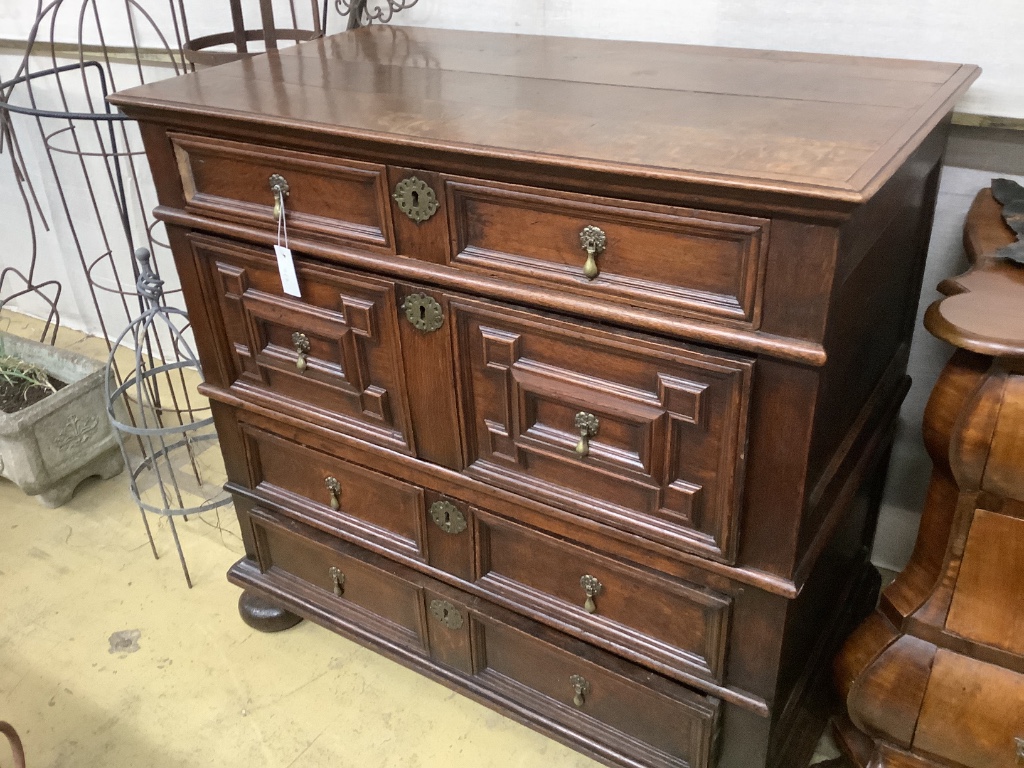 An 18th century oak geometric moulded two part chest, width 105cm, depth 58cm, height 100cm